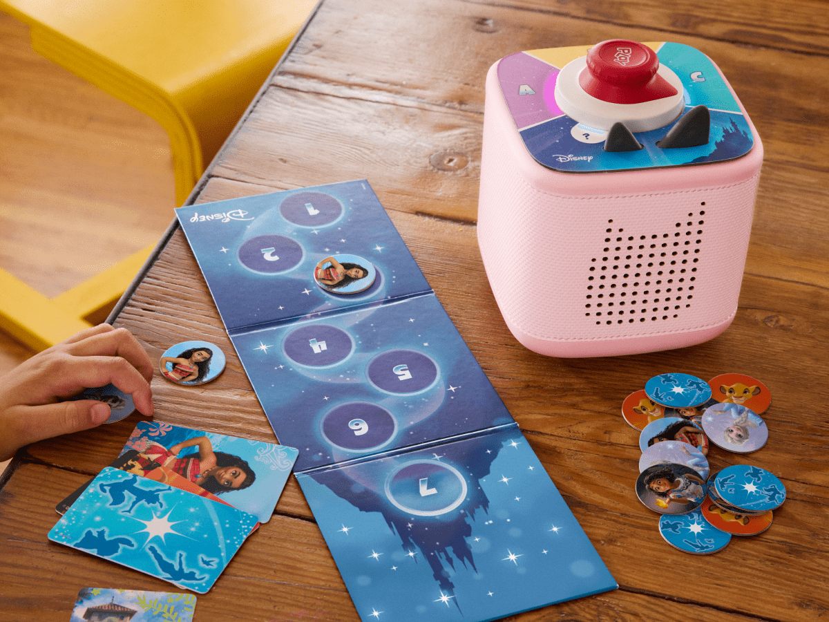 child playing with pink Toniebox 2, tonieplay controller and disney tonieplay game