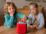 Kids playing with a red toniebox 2 and unlucky jo tonieplay