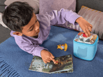 child playing with Toniebox 2 an audio player for kids with Winnie the Pooh Tonie audio figurine and Winnie the Pooh Tiggers Mixup Fixup Tonieplay Game